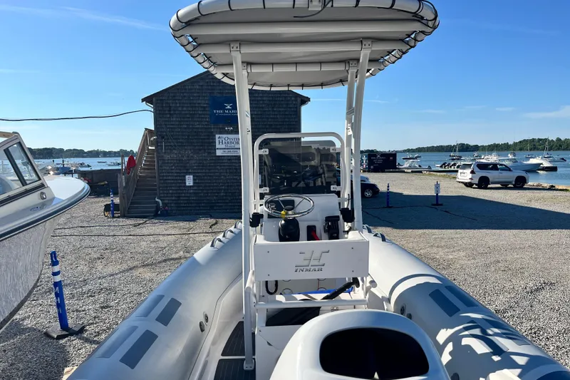 Slide: The Image of 2023 Inmar 550R-YS Yacht Series at marina with boats and clear blue sky. - 9