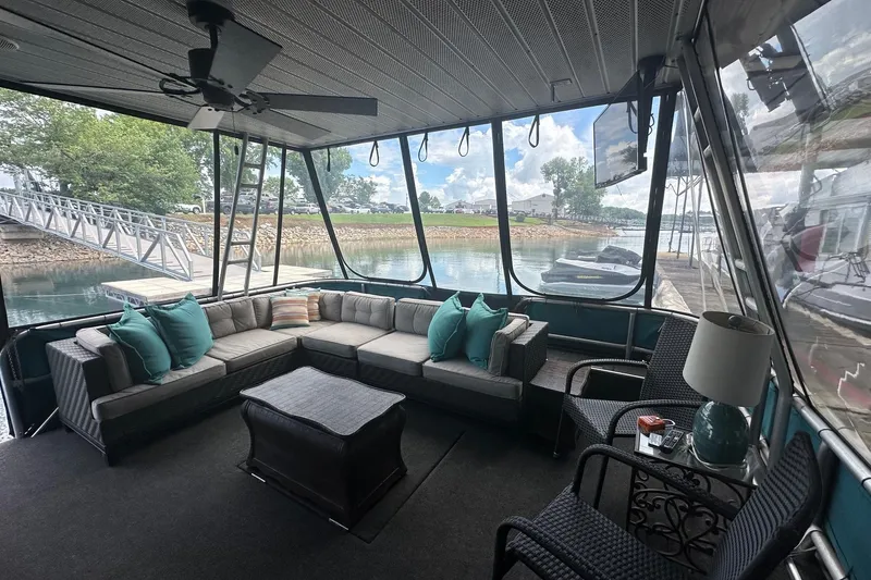 Slide: The Image of Spacious 1992 Sumerset 14x64 houseboat interior with cozy seating and scenic lake view. - 1