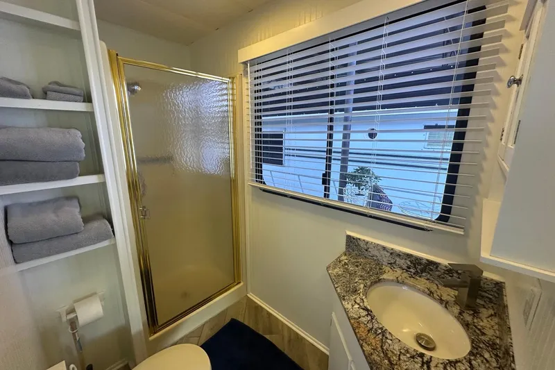 Slide: The Image of Bathroom in 1992 Sumerset 14x64 houseboat with shower, sink, and window blinds. - 11