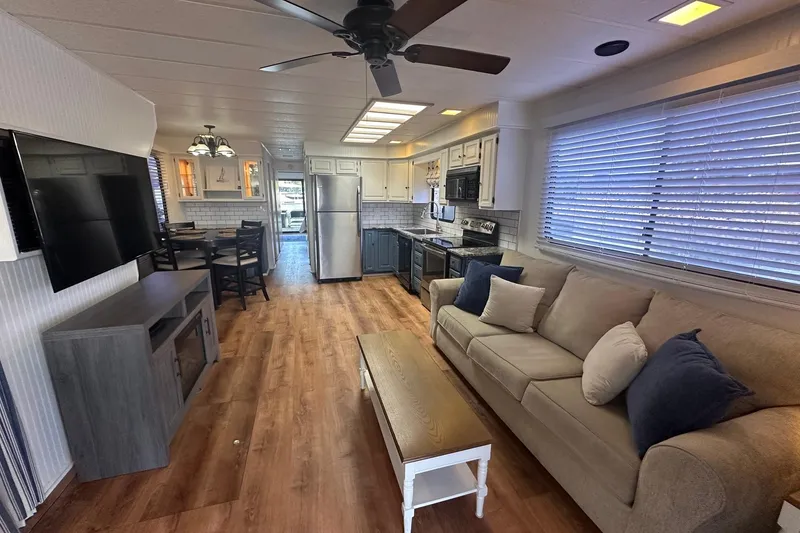 Slide: The Image of Interior of a 1992 Sumerset 14x64 houseboat with modern kitchen and cozy living area. - 2