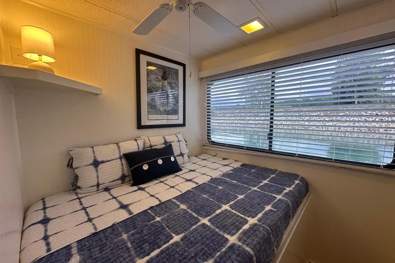 Slide: The Image of Cozy bedroom in 1992 Sumerset 14x64 houseboat with nautical decor and large window view. - 6
