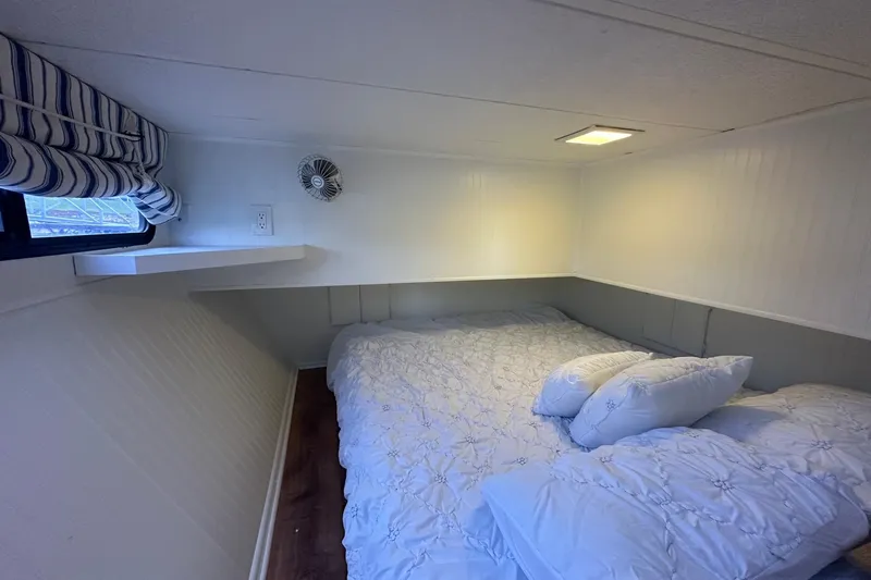 Slide: The Image of Cozy bedroom in a 1992 Sumerset 14x64 houseboat with a comfortable bed and window view. - 7