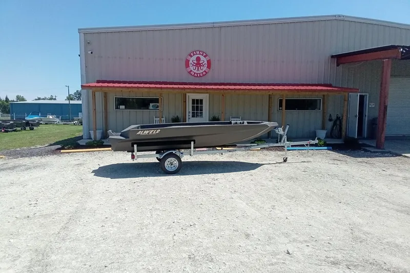 Slide: The Image of 2026 Alweld 1652 Invader boat on trailer outside a warehouse. - 12