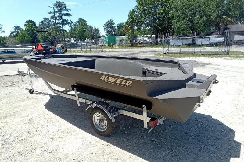 Slide: The Image of 2026 Alweld 1652 Invader boat on trailer, parked outdoors in a sunny setting. - 18