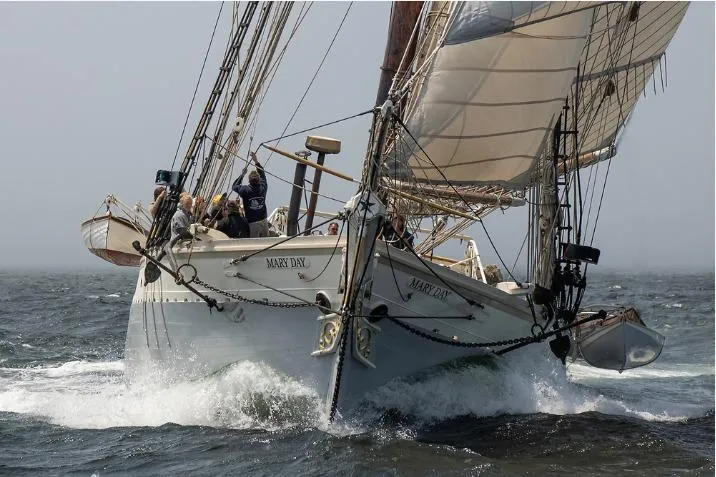 Slide: The Image of Classic 1962 Coasting Schooner sailing on rough seas with full sails and crew. - 2