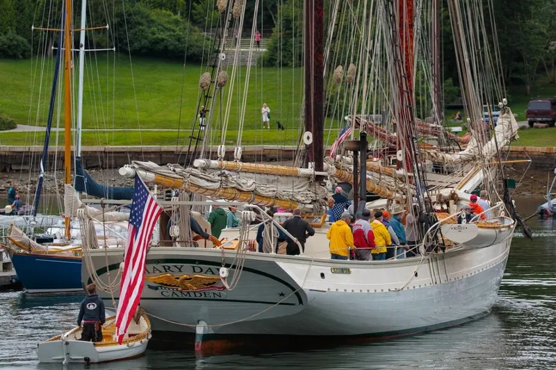 Slide: The Image of Classic 1962 Coasting Schooner with American flag, docked with passengers onboard. - 7