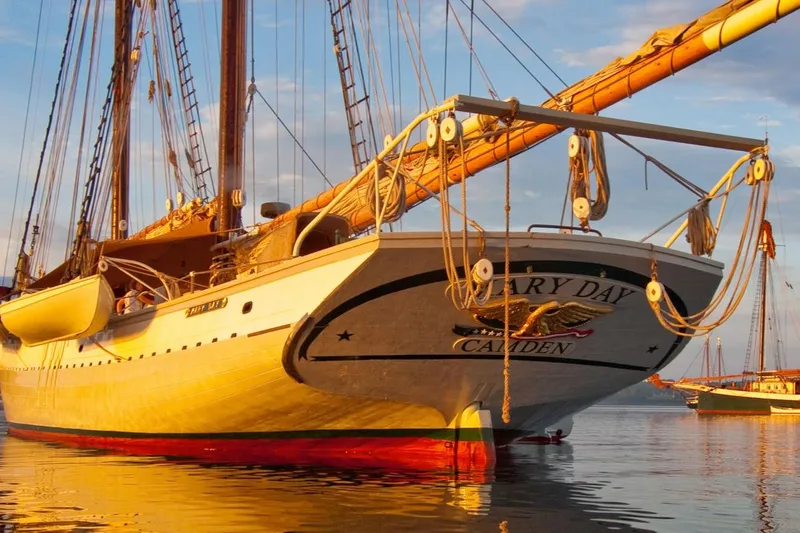 Slide: The Image of Classic 1962 Coasting Schooner in calm waters at sunset, showcasing elegant design. - 8