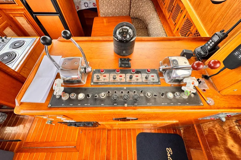 Slide: The Image of Control panel of a 1985 Symbol 51 yacht with navigation instruments and throttle levers. - 14