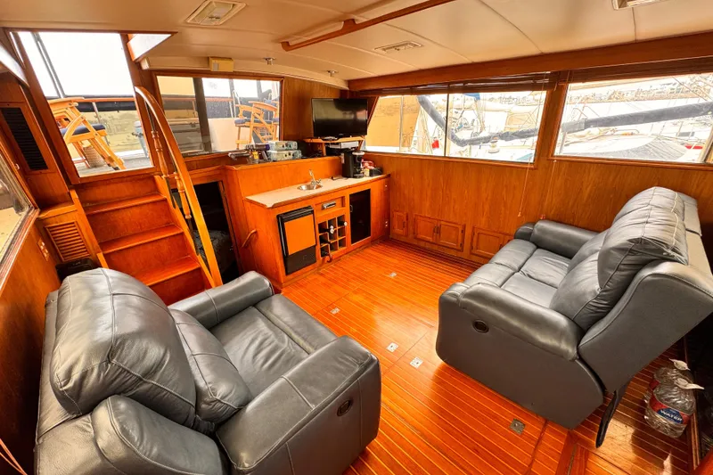 Slide: The Image of Luxurious 1985 Symbol 51 yacht interior with leather seating and wooden flooring. - 16