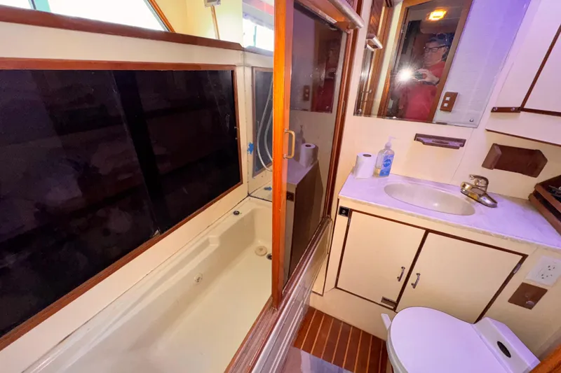 Slide: The Image of Compact 1985 Symbol 51 yacht bathroom with shower, sink, and toilet. - 18