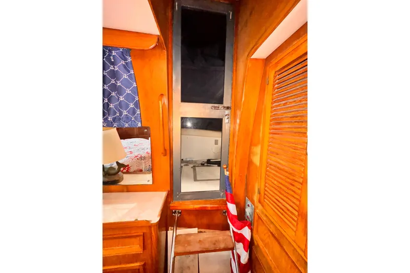 Slide: The Image of Cozy 1985 Symbol 51 yacht interior with wooden paneling and nautical decor. - 19