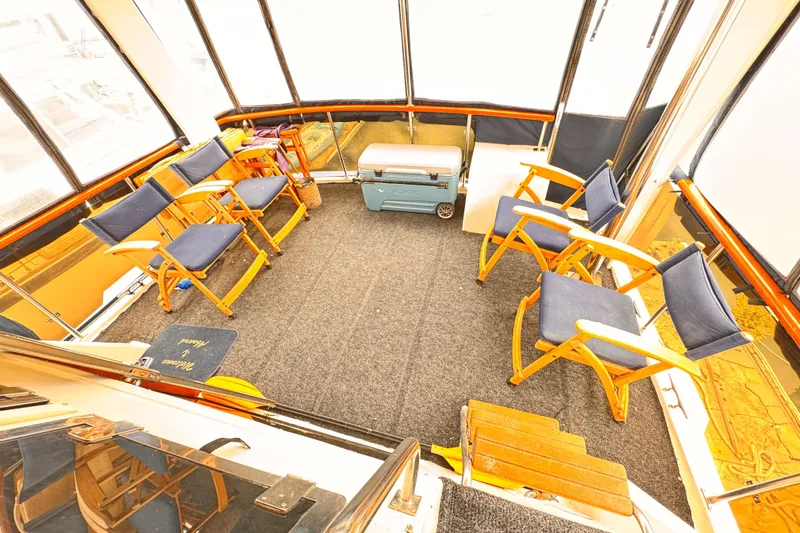 Slide: The Image of Enclosed boat deck with blue chairs and cooler, Symbol 51, 1985 model. - 23