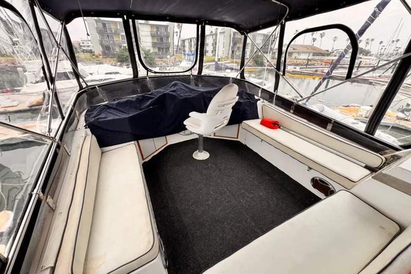 Slide: The Image of Interior of a 1985 Symbol 51 boat with seating and marina view. - 24