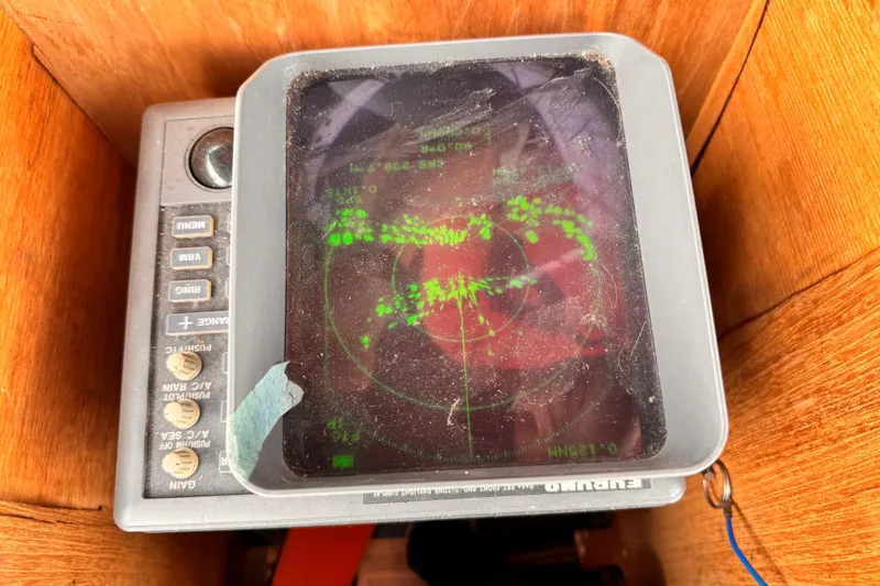 Slide: The Image of Vintage 1985 Symbol 51 radar display with green data on screen, housed in wooden enclosure. - 26