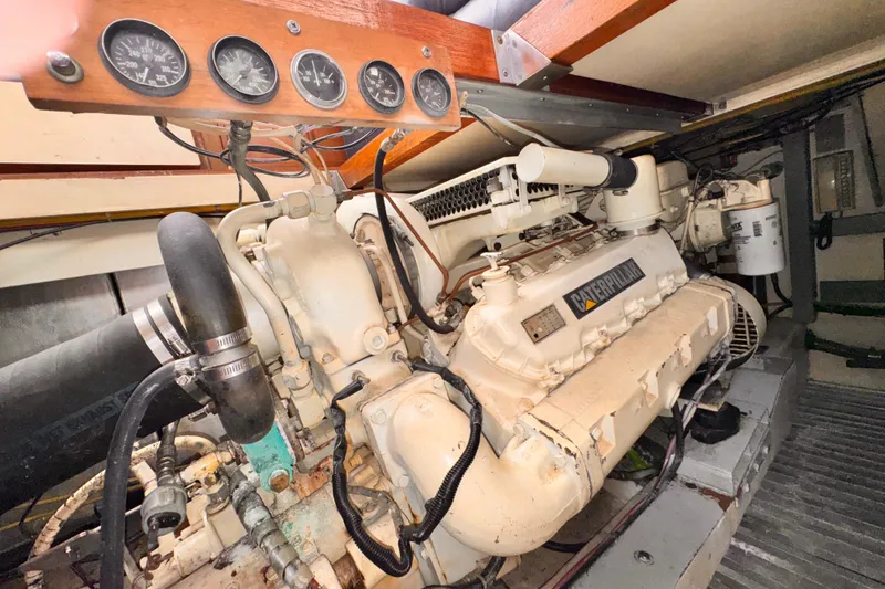 Slide: The Image of Engine room of a 1985 Symbol 51 yacht with Caterpillar engine and gauges. - 32
