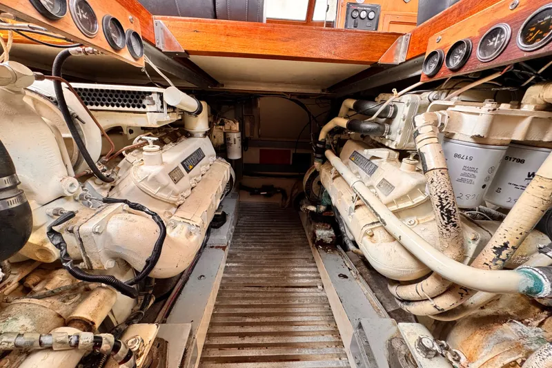 Slide: The Image of Engine room of a 1985 Symbol 51 yacht, featuring dual diesel engines. - 35
