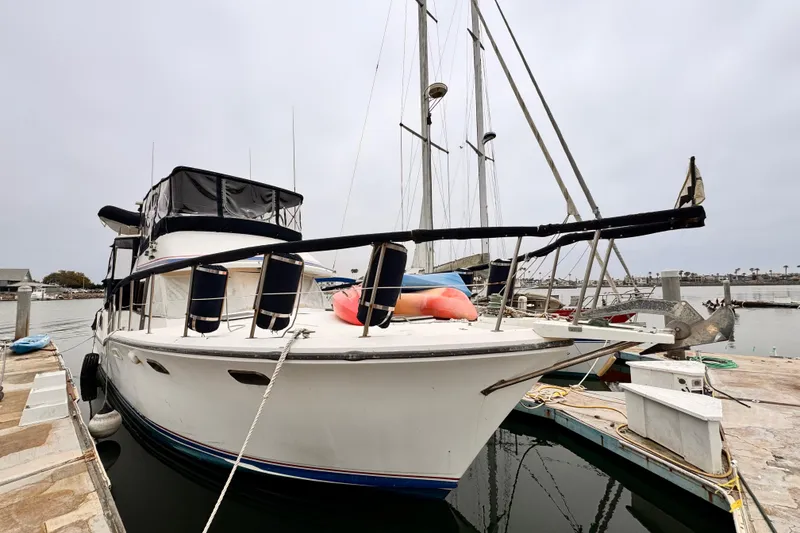 Slide: The Image of 1985 Symbol 51 yacht docked at marina, overcast sky, calm waters. - 38