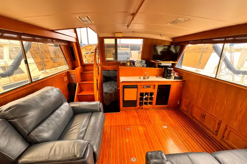 Slide: The Image of Luxurious 1985 Symbol 51 yacht interior with leather seating, wood paneling, and kitchenette. - 7