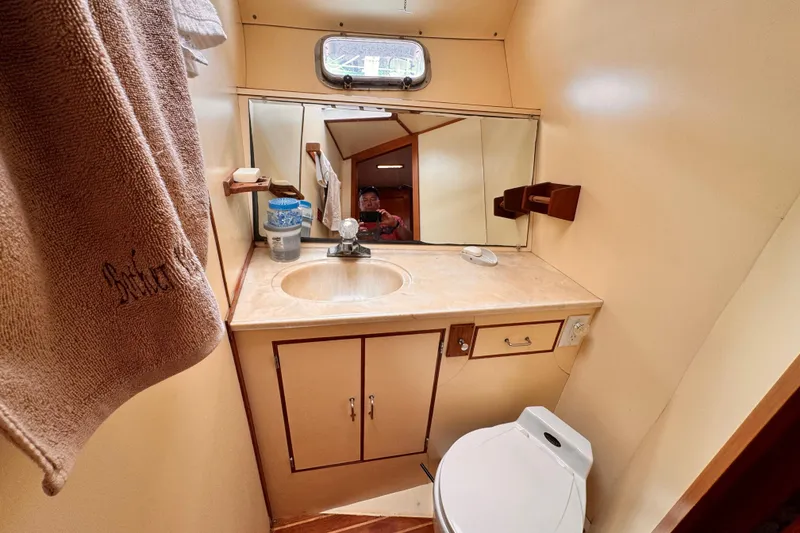 Slide: The Image of Compact 1985 Symbol 51 yacht bathroom with sink, mirror, and toilet. - 9