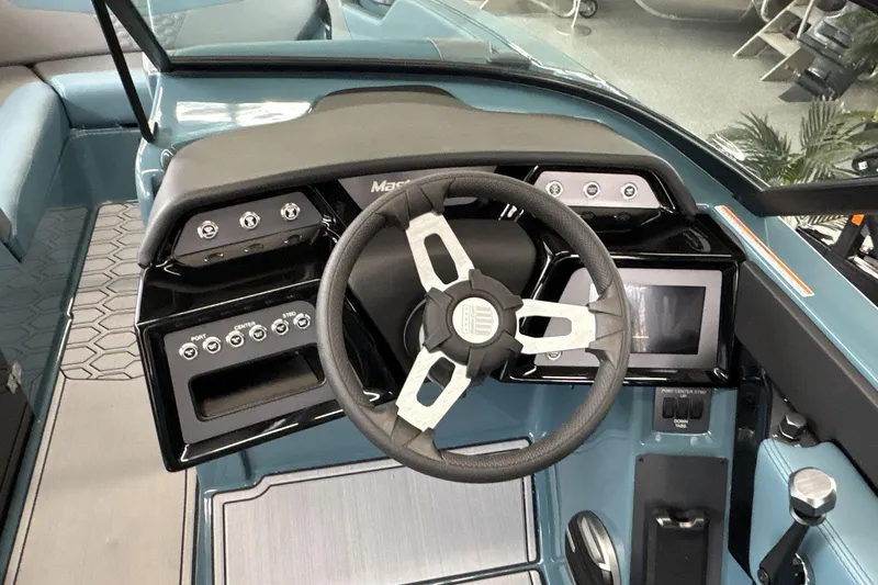 Slide: The Image of 2026 MasterCraft NXT22 boat dashboard with steering wheel and control panel. - 10