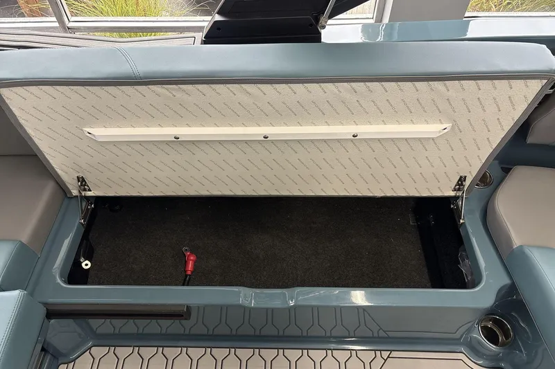 Slide: The Image of Open storage compartment in 2026 MasterCraft NXT22 boat, showcasing interior design. - 19