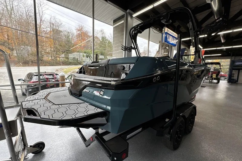 Slide: The Image of 2026 MasterCraft NXT22 boat displayed indoors, showcasing sleek design and modern features. - 3