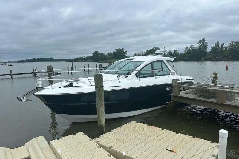 Slide: The Image of 2018 Monterey 360 Sport Coupe docked on a cloudy day by the water. - 1