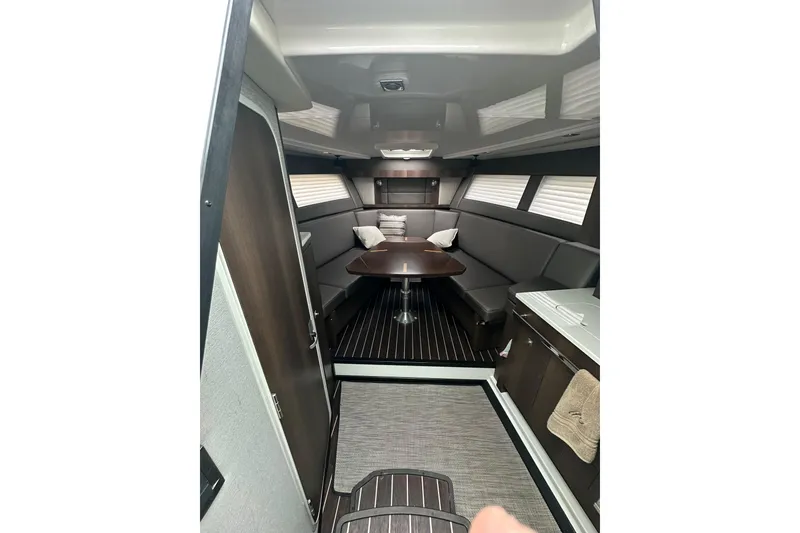 Slide: The Image of Interior of a 2018 Monterey 360 Sport Coupe, featuring a sleek dining area and modern design. - 20