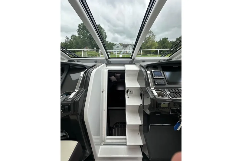 Slide: The Image of Interior view of a 2018 Monterey 360 Sport Coupe boat cockpit with control panels. - 21