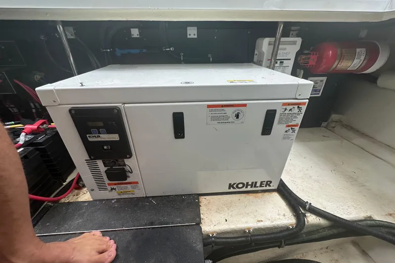 Slide: The Image of Kohler generator in a 2018 Monterey 360 Sport Coupe engine room with fire extinguisher. - 25