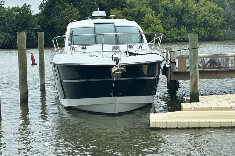 Slide: The Image of 2018 Monterey 360 Sport Coupe docked on a calm river with lush greenery. - 3