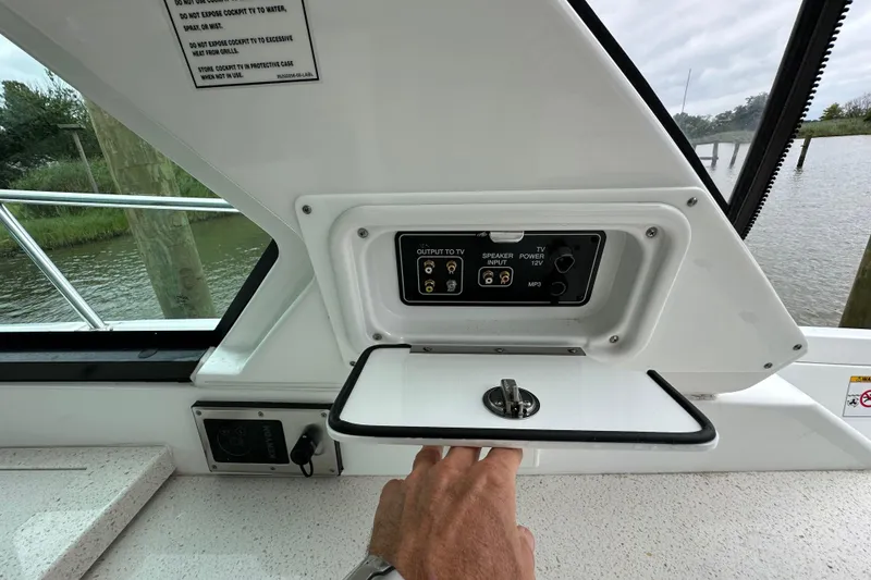 Slide: The Image of Control panel on a 2018 Monterey 360 Sport Coupe boat, featuring audio and TV outputs. - 7