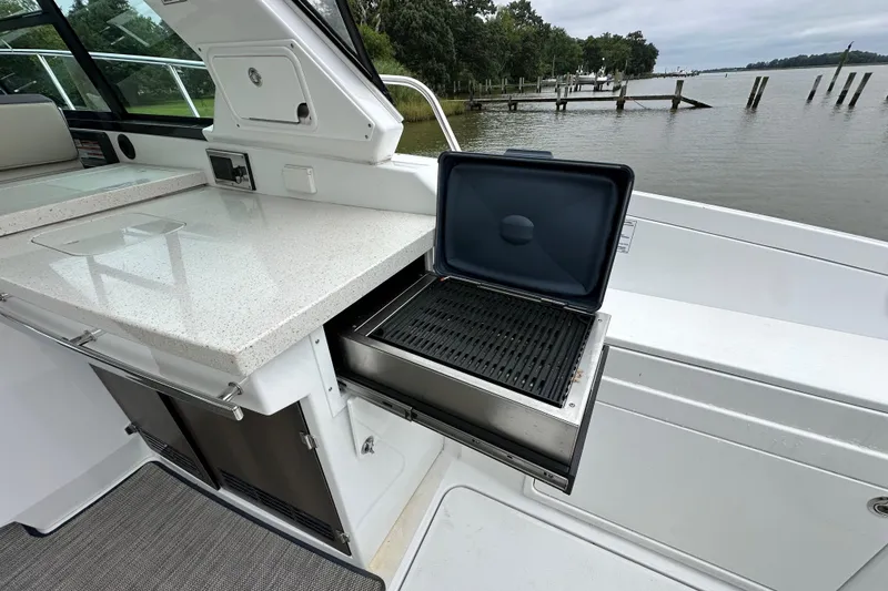 Slide: The Image of Outdoor grill on 2018 Monterey 360 Sport Coupe yacht, overlooking serene waterfront. - 8