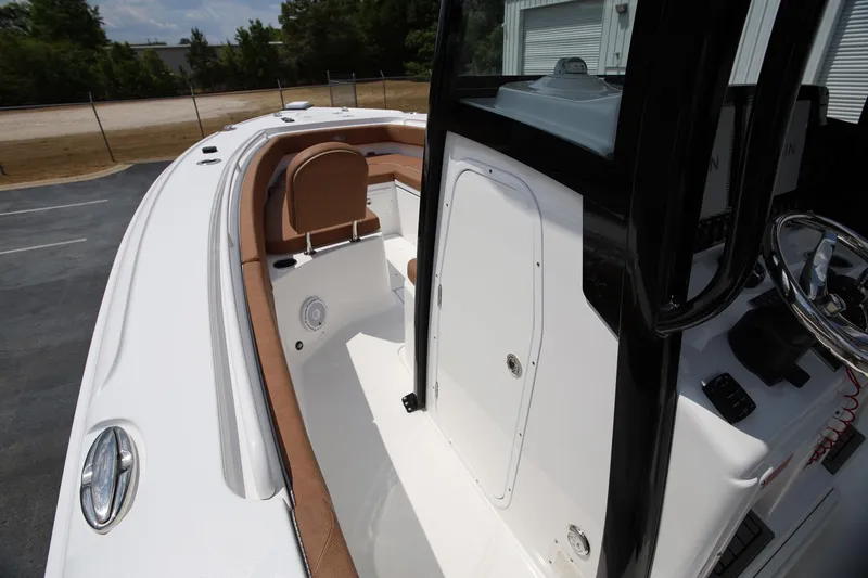 Slide: The Image of 2024 Sea Hunt Ultra 275 SE boat interior with seating and steering console. - 12