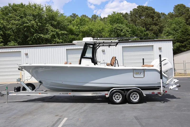 Slide: The Image of 2024 Sea Hunt Ultra 275 SE boat on trailer, parked outdoors. - 3