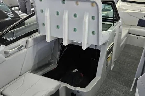 Slide: The Image of 2026 MasterCraft XT24 boat interior with open storage compartment and seating. - 12