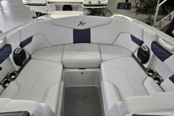 Slide: The Image of 2026 MasterCraft XT24 boat interior with white and blue seating. - 14