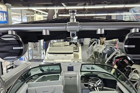 Slide: The Image of 2026 MasterCraft XT24 boat interior with advanced audio system in showroom. - 18