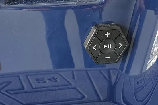 Slide: The Image of Hexagonal control panel on 2026 MasterCraft XT24 boat, featuring playback and volume buttons. - 20