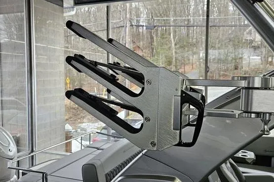 Slide: The Image of 2026 MasterCraft XT24 boat with a sleek wakeboard rack in a showroom setting. - 23