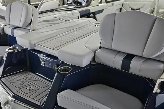 Slide: The Image of 2026 MasterCraft XT24 boat interior with gray seating and cup holders. - 4