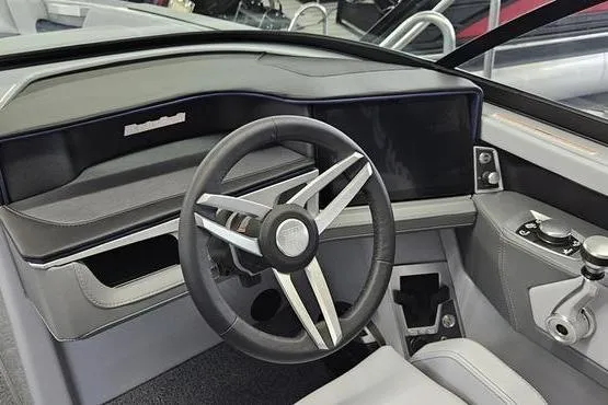 Slide: The Image of 2026 MasterCraft XT24 boat interior with modern steering wheel and dashboard controls. - 9