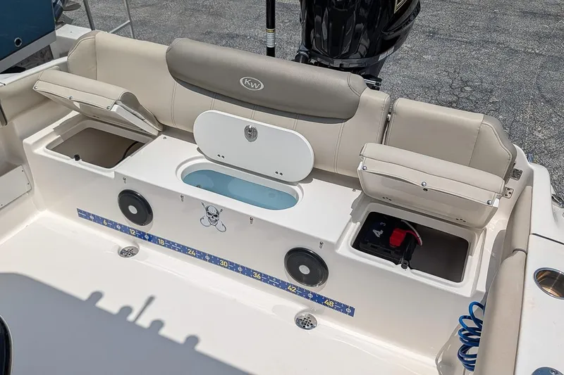 Slide: The Image of 2024 Key West 239 FS boat interior with storage compartments and seating. - 10