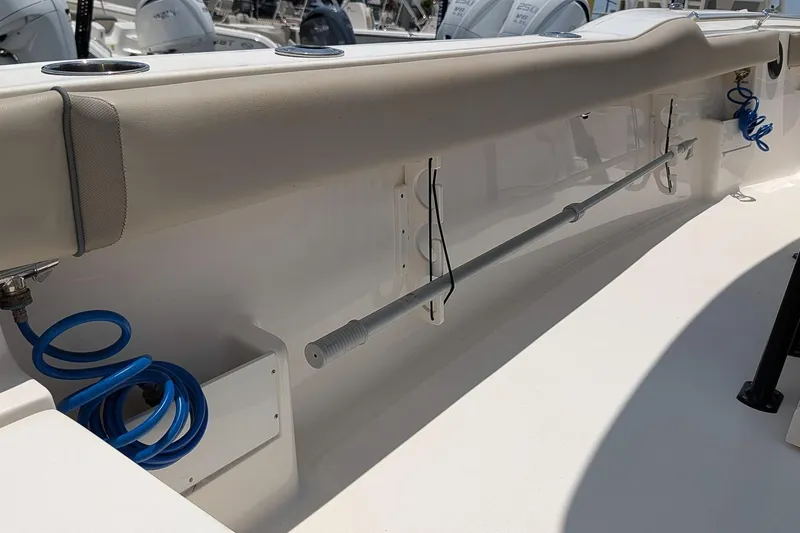 Slide: The Image of 2024 Key West 239 FS boat interior with rod holder and blue coiled hose. - 12