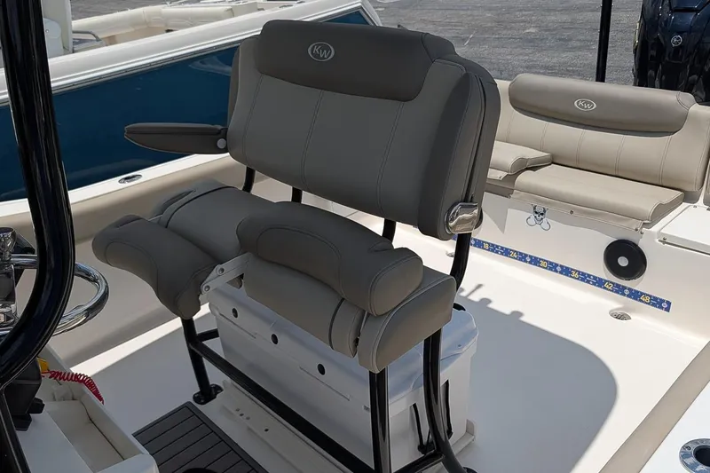 Slide: The Image of 2024 Key West 239 FS boat interior with cushioned seating and steering console. - 13