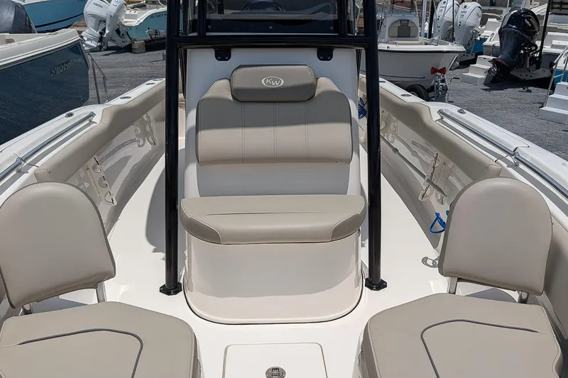 Slide: The Image of 2024 Key West 239 FS boat interior with beige seating and console. - 17