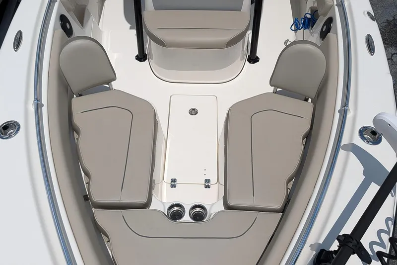 Slide: The Image of 2024 Key West 239 FS boat interior with beige seating and storage compartments. - 19