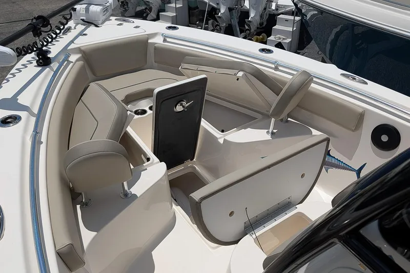 Slide: The Image of 2024 Key West 239 FS boat interior with seating and storage compartments. - 21