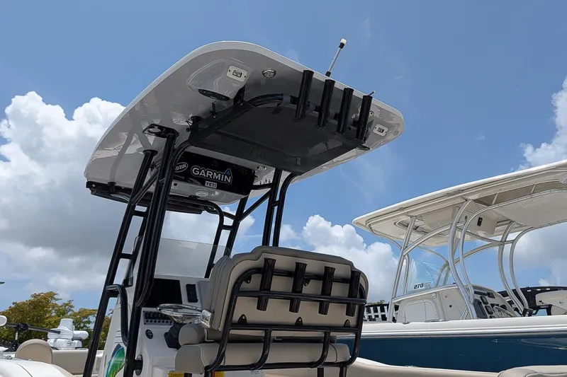Slide: The Image of 2024 Key West 239 FS boat with T-top and Garmin electronics under a clear blue sky. - 23