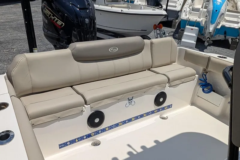 Slide: The Image of 2024 Key West 239 FS boat interior with beige seating and Yamaha engine. - 9